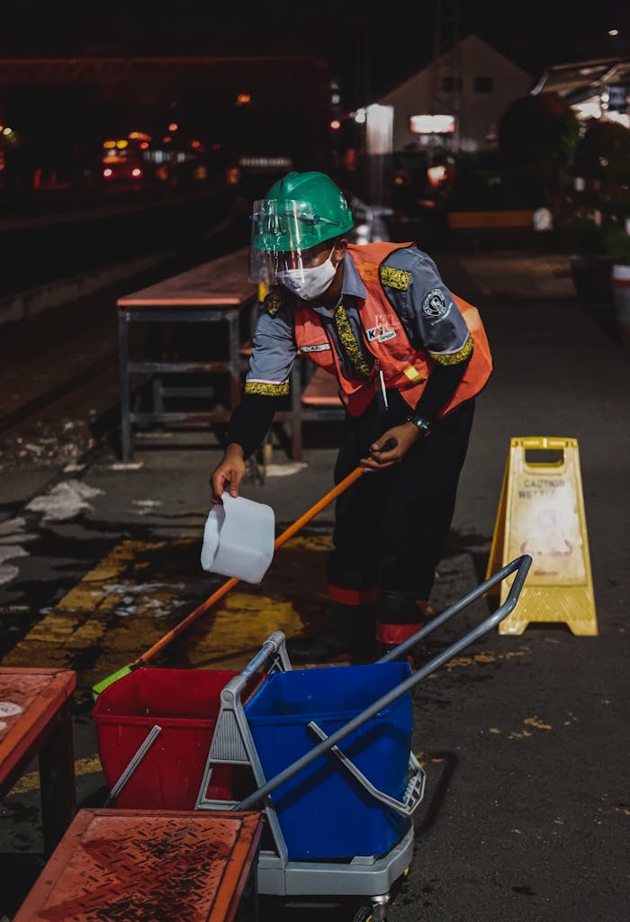 Crafting Captivating Headlines: Your awesome post title goes here A worker cleans a Jakarta railway station platform at night, emphasizing maintenance and hygiene.